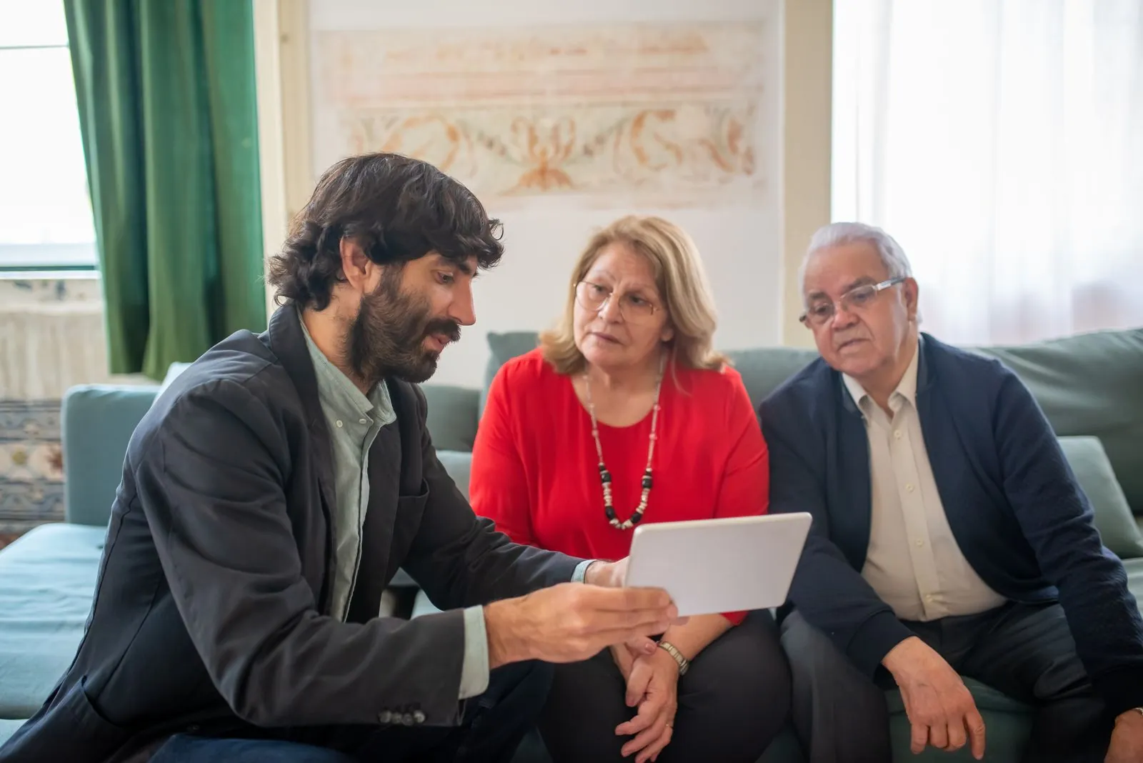 Advisor presenting options to an older couple on a tablet