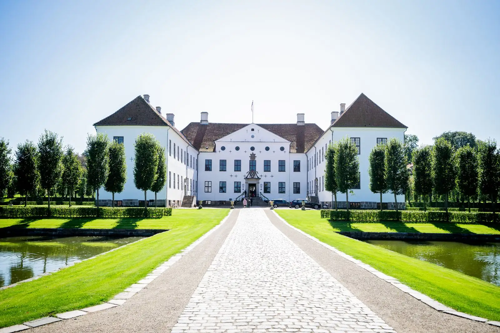 White countryside mansion with formal gardens