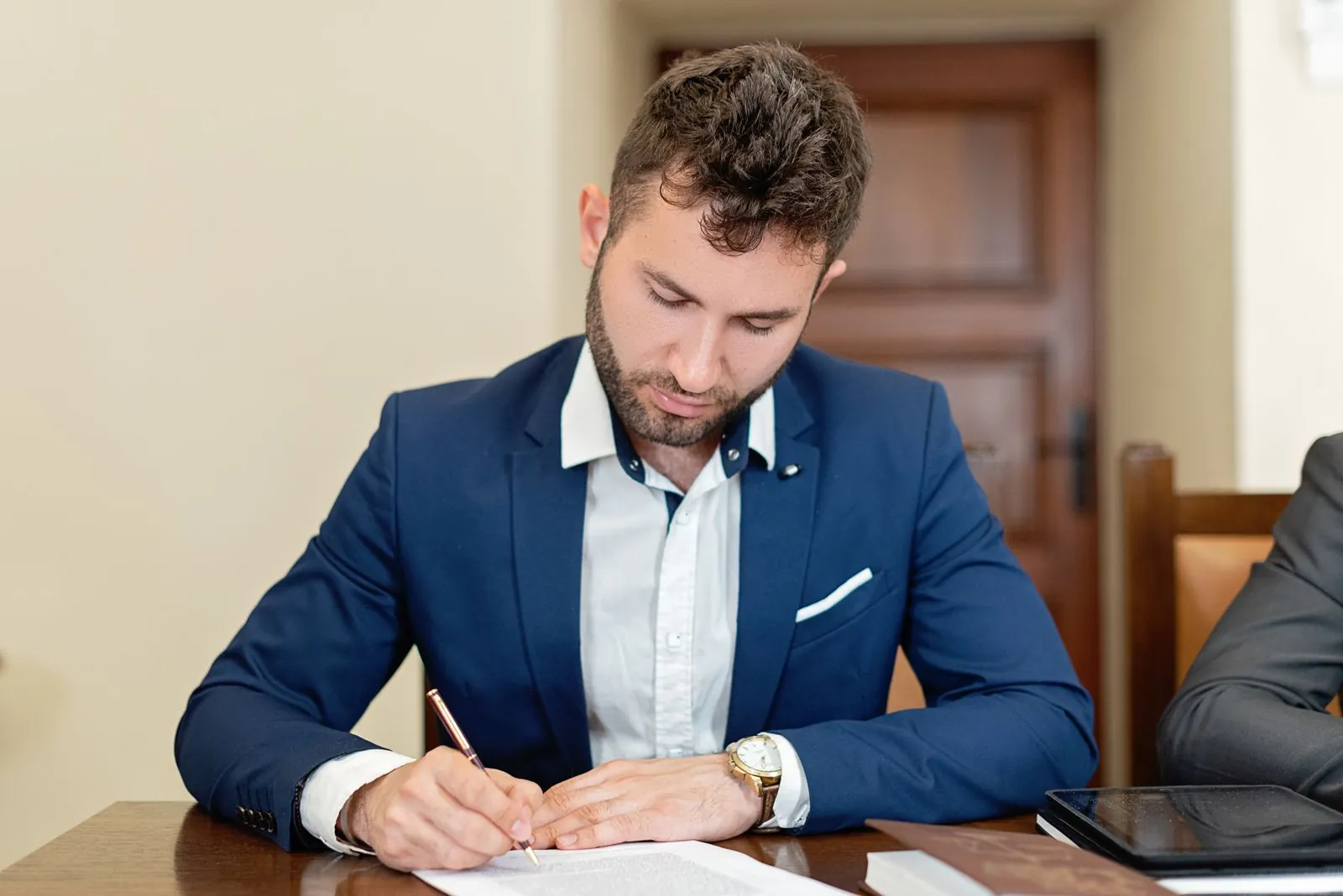 Business owner signing formation documents at a desk