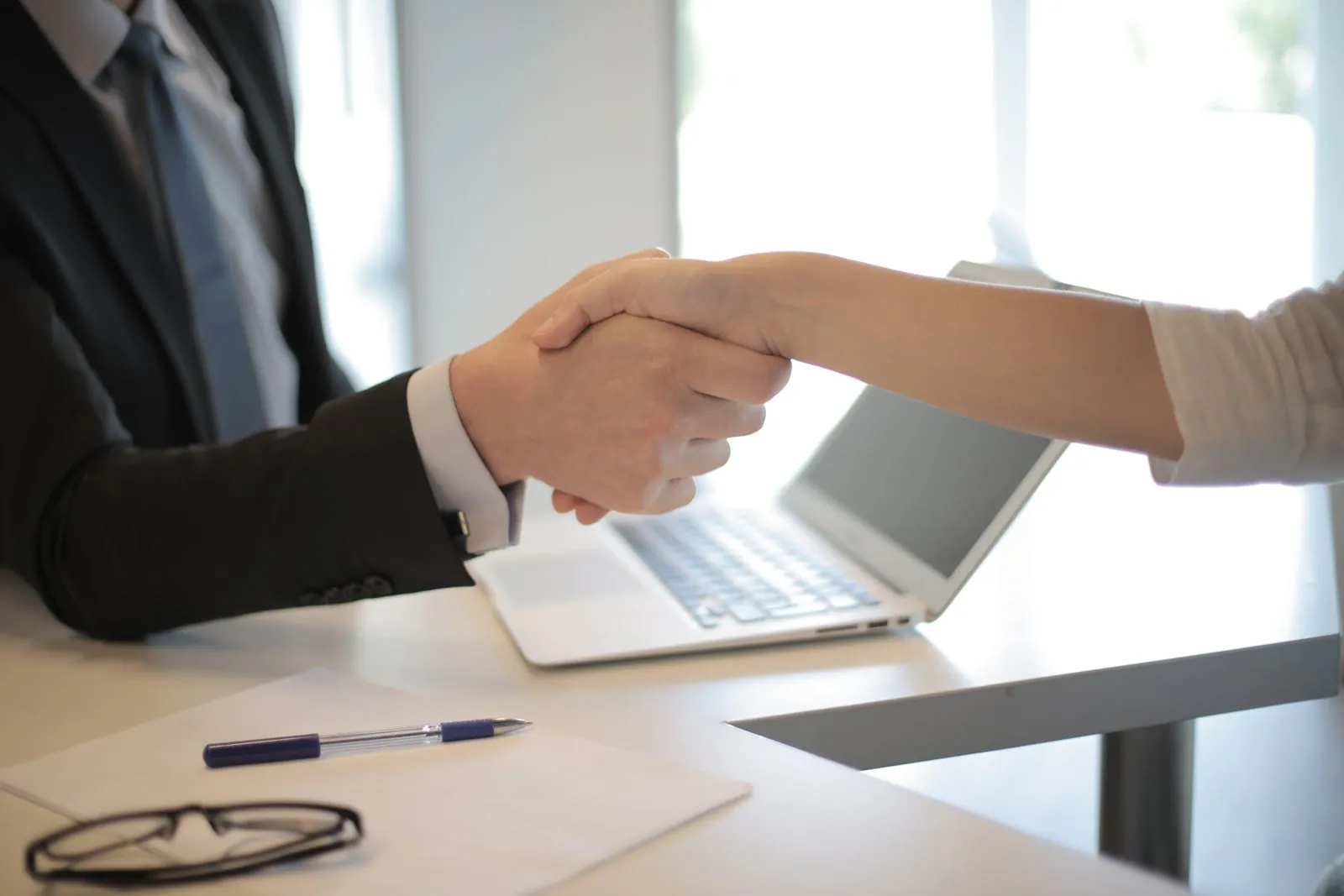 Handshake over a desk after a hiring decision